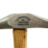 Close-up of a hammer head with a wooden handle. The hammer head is stamped with the text "C.S. OSBORNE & CO 65 MADE IN USA FORGED STEEL". The hammer is made of metal and wood.