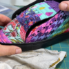 Colorful custom quilted sneakers featuring patterned fabric panels and black rubber soles, demonstrating a finished sneaker customization project.